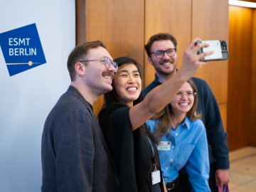 A group of MBA students taking a selfie together at the ESMT Berlin Career Fair 2026
