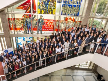 The ESMT master's students from the Class of 2027 gathering on the staircase for a group photo