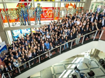 The ESMT master's students from the Class of 2027 gathering on the staircase for a group photo