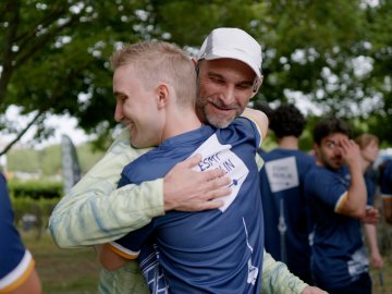 ESMT Berlin professor Eric Quinane hugging a student after a successful relay race