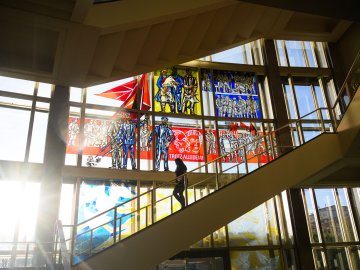 Staircase and stained-glass windows inside ESMT Berlin's historic campus in the former Staatsratsgebäude.