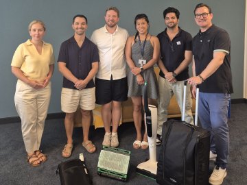 ESMT Berlin Full-time MBA students during their Sustainability in Practice program with Vorwerk, holding a Kobold vacuum cleaner