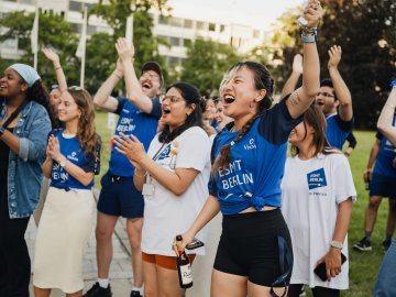Full-time MBA students Ting Han and Roshni Dutta cheering in the garden during the ESMT school olympics