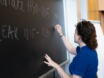 Faculty member working at a blackboard at ESMT Berlin.