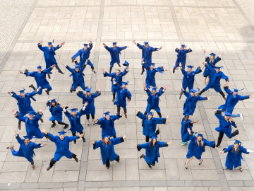 The ESMT Berlin Executive MBA Class of 2026 celebrating graduation in their robes and mortarboards