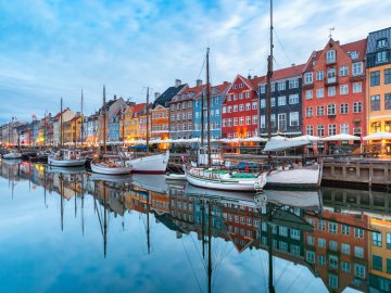 An image of brightly colored, 17th-century canal houses in Nyhavn, the waterfront district in Copenhagen, Denmark