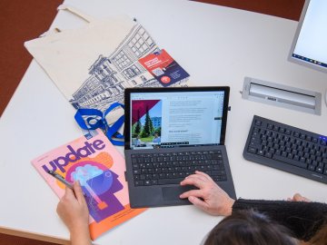 Laptop and ESMT Update magazine on the desk