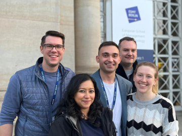 ESMT Berlin Part-time MBA students Pavel Seraphimov, Jan Zimmermann, Alessandra Sternberg and classmates standing outside the ESMT campus building