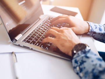 Global Online MBA student checking curriculum