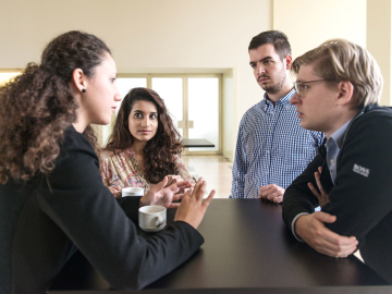 4 people discussion over a cup of coffee