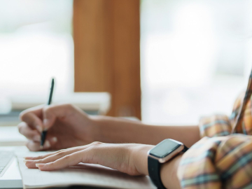 person writing on a notepad