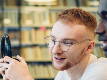 Image of students working together in an office
