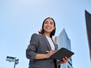 business woman leader standing on the street in big city
