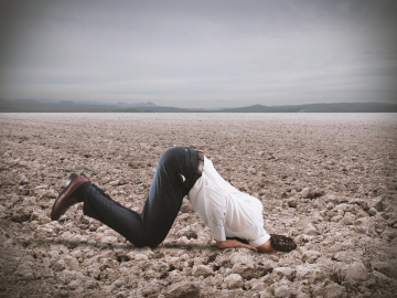 Afraid businessman hides his head
