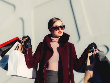 well-dressed person in sunglasses after a shopping spree