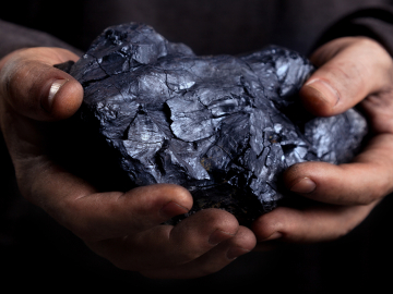 Piece of coal in a man's hands