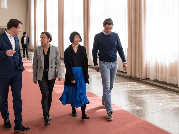 4 students talking and walking together at ESMT campus