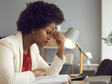 Frustrated african american woman keeping eyes closed and massaging nose