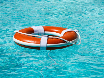 Life buoy in blue swimming pool.