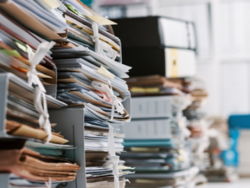 A big amount of files on an office desk are being shown.