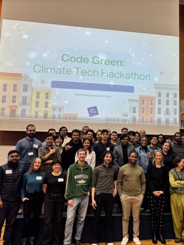 The ESMT Climate Hackathon team posing on stage