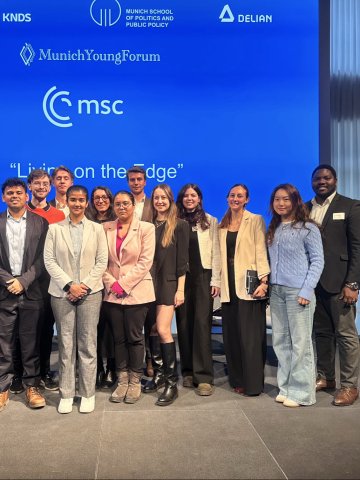 A group of ESMT master's and MBA students standing on stage at the Munich Young Forum 