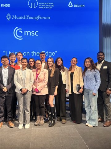 A group of ESMT master's and MBA students standing on stage at the Munich Young Forum 