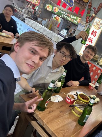 ESMT master's students celebrating at a restaurant in Shanghai after winning a consultancy competition at ZIBS