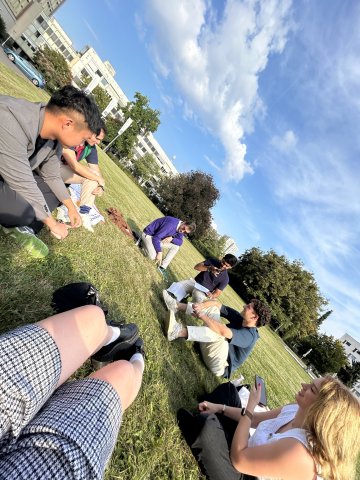 Master in Innovation and Entrepreneurship student Valentina Vergara Stange and friends in the ESMT Berlin campus garden in the sunshine