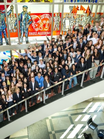 The ESMT master's students from the Class of 2027 gathering on the staircase for a group photo