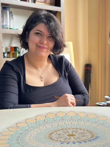 ESMT Berlin Full-time MBA alum Anahita Moaddab with her traditional Persian artwork