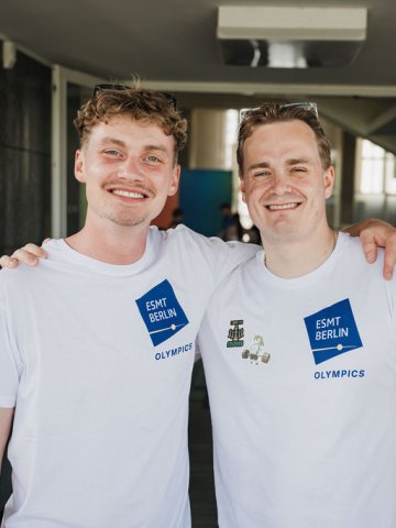 ESMT Berlin Master in Analytics and AI student Fynn Barkhausen and Master in Global Management student Lucas Wall smiling for the camera at the ESMT Olympics