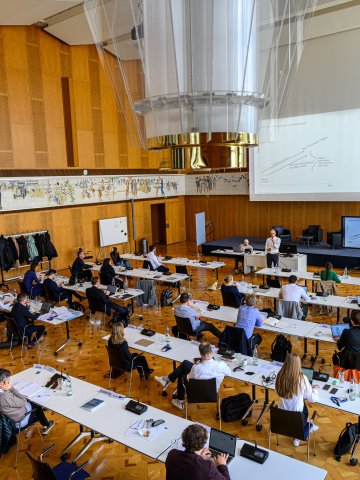 Faculty member teaching students in a modern classroom within ESMT Berlin's historic Learning Center.