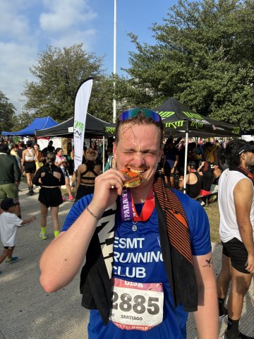  ESMT Berlin master's student and running club member Fynn Barkhausen with a medal he received after a race