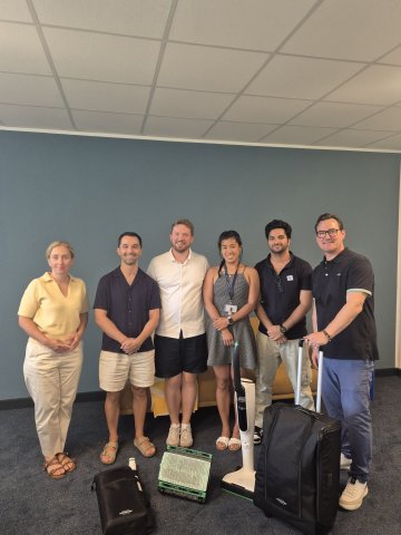 ESMT Berlin Full-time MBA students during their Sustainability in Practice program with Vorwerk, holding a Kobold vacuum cleaner