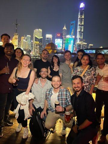 ESMT Berlin Part-time MBA student Flor Massei and her cohort on a rooftop in Shanghai, China, celebrating the end of their International Field Seminar