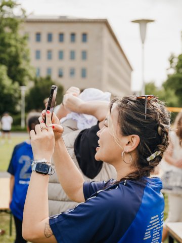ESMT Berlin Full-time MBA students Ting Han taking a photo in the garden at the school Olympics 