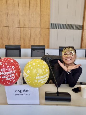 ESMT Berlin Full-time MBA student Ting Han celebrating her birthday on campus by wearing golden glasses and holding balloons
