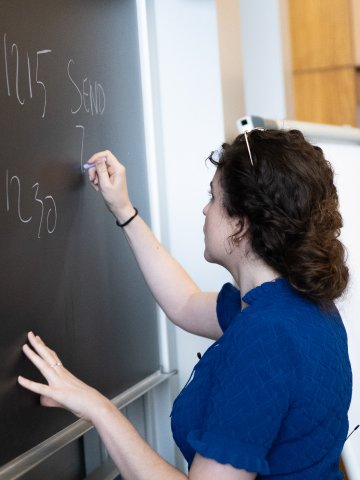 Faculty member working at a blackboard at ESMT Berlin.
