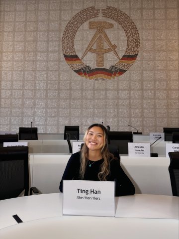 ESMT Berlin student Ting Han in front of a mosaic in an auditorium on the school's historical campus