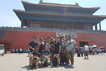 The ESMT Berlin Full-time MBA class of 2019 standing n front of the temple on a class trip to China