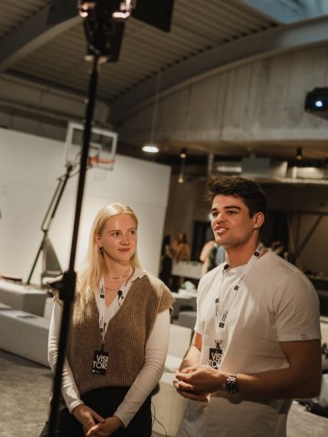 Two ESMT Berlin Master in Innovation and Entrepreneurship students talking to a camera person about their venture building idea