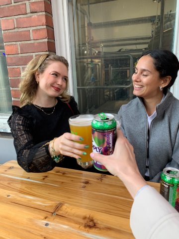 ESMT Berlin Master in Innovation and Entrepreneurship students Jasmin Mantwill, Laura Ruiz, and Gwyneth-Tyger Carys Neumann celebrating at a restaurant after the Innova competition