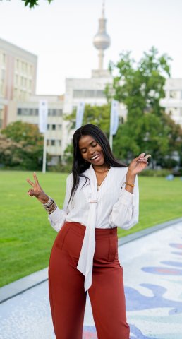 ESMT Berlin Global Online MBA student Joan Mwaniki smiling for the camera while on campus for Berlin Experience Week