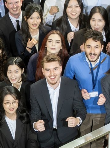 ESMT Berlin master's students on the school staircase, including Master in Global Management student Can Mert Basdere in the center of the group
