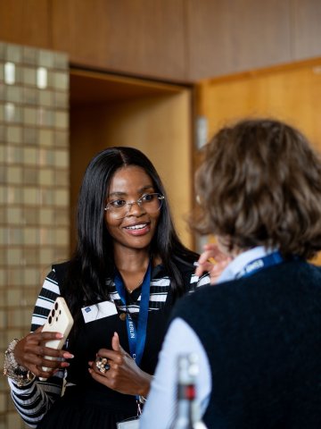 ESMT Berlin Global Online MBA student Joan Mwaniki and a colleague discussing class while on the ESMT campus