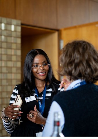 ESMT Berlin Global Online MBA student Joan Mwaniki and a colleague discussing class while on the ESMT campus
