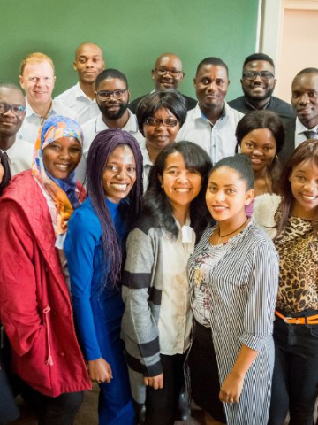 African students posing for group photo with professors