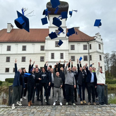 GMS participants on the last day throwing graduation hats up in the air