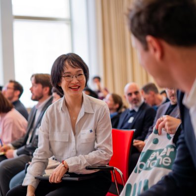 Full-time MBA student Lindy Lin at an ESMT Berlin career fair, smiling with another course mate